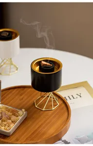 Modern Nordic ceramic incense burner with metal stand, elegant desktop aromatherapy decor.