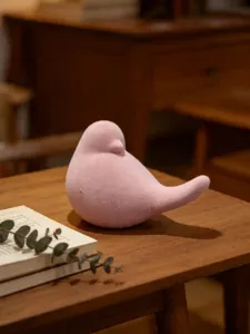 Pink flocked abstract bird figurine tabletop ornament for home decor and desk styling.