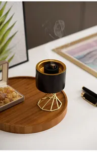 Modern Nordic ceramic incense burner detail, gold metal geometric stand, aromatherapy setup for desktop decor.