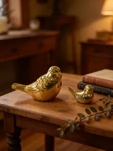 Elegant gold ceramic bird figurines set for tabletop home decor and artistic desktop styling.