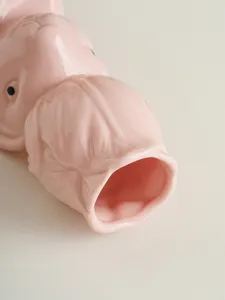 Ceramic rabbit vase detail, pink glossy flower holder, unique animal art decor piece.