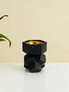 Modern black geometric resin incense burner with gold interior for aromatherapy and home decor.