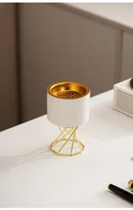 Modern Nordic ceramic incense burner with gold metal stand for elegant home tabletop decor.