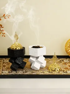 Detailed view of Arabic resin incense burner with geometric blocks and ornate gold lid.