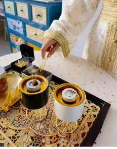 Detail shot of modern Nordic ceramic incense burner with golden metal stand for home decor.