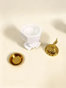 Detailed view of the disassembled Middle Eastern resin incense burner parts and golden components.