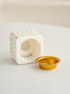 Close-up detail of white 3D printed ceramic incense burner with woven geometric pattern.