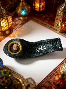 Detailed close-up of the elegant black resin boat incense burner with Arabic calligraphy script and gold tray.