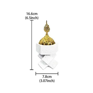 Detail view of Middle Eastern resin incense burner with gold dome and cross knot design.