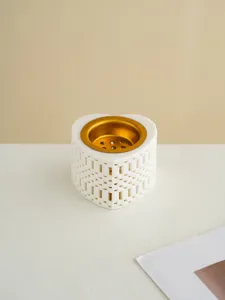 Detailed close-up shot of a heart-shaped ceramic incense burner with a gold inner bowl.