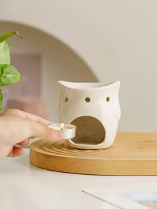 Ceramic owl oil burner candle holder for modern home decoration and relaxing aromatherapy.