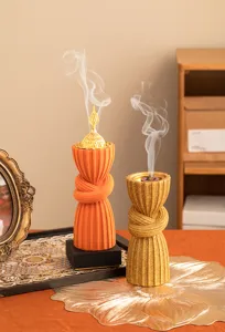 Resin Arabian style incense burner detail showing unique tied waist shape and smoke effect orange