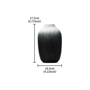 Detail shot of the black and white gradient resin vase showing its vertical ribbed texture.