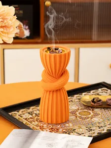 Exquisite orange resin incense burner featuring a unique knot pillar design, ideal for home decor.
