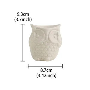 Detail shot of white ceramic owl aroma burner, candle holder and home decor piece 9.3cm