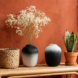 Minimalist black and white gradient resin vase with dried flowers for home decor.