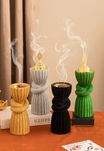 Detailed shot of Arabic style resin incense burners featuring golden lids and textured twisted design.