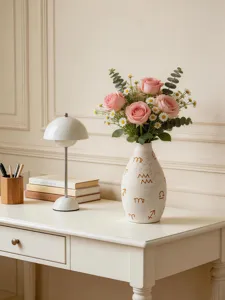 Modern aesthetic ceramic flower vase featuring zodiac symbols and pink rose bouquet detail view.