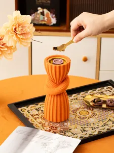Detailed view of an orange resin Arabian style incense burner with a unique knotted design.