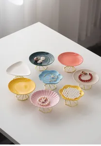 Ceramic jewelry tray detail view, multi-color modern ring and bracelet display stand.