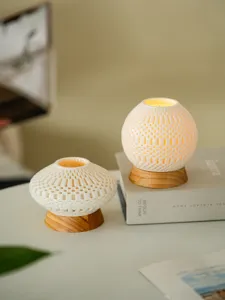 Minimalist 3D printed ceramic hollow candle holder with wooden base for home decor and wedding.