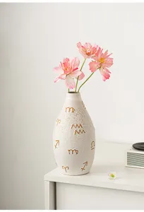 Modern ceramic flower vase with artistic golden zodiac symbols, perfect for desktop floral decor.
