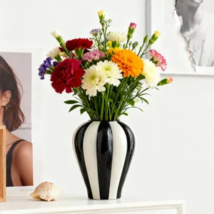 Nordic minimalist black and white ceramic vase, flower arrangement detail for home decor.