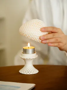 White ceramic hollow 3d printed candle holder detail view, elegant home table decor.