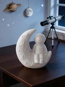 Ceramic astronaut moon ornament detail, creative home decor for desktop, shelf, room styling.
