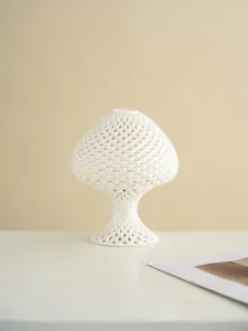 White hollow 3d printed mushroom candle holder, elegant home decor art sculpture detail shot.