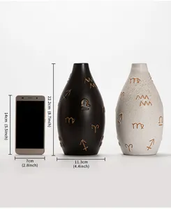 Modern ceramic vase with artistic symbol patterns, desktop floral container for home decoration.