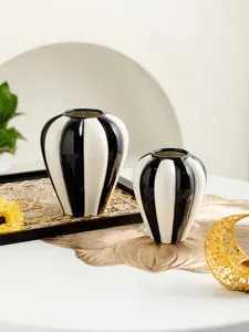 Nordic minimalist black and white ceramic vase detail shot, glossy striped finish home decor.