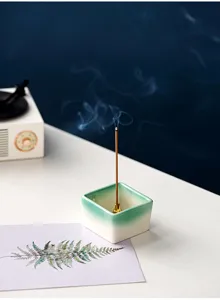 Minimalist square ceramic incense holder with green gradient finish and brass holder stick.