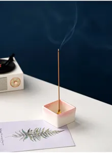 Detailed close-up of the minimalist square ceramic incense burner featuring a pink gradient.