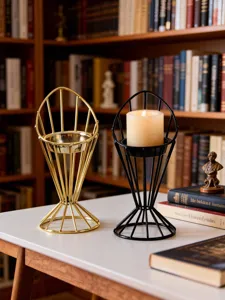 Modern minimalist metal candle holder set in gold and black with candle for home decor detail.