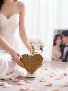 Exquisite heart ceramic vase detail, golden textured surface, romantic floral home decor.