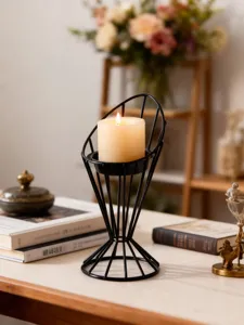 Modern minimalist black metal geometric candle holder with scented wax candle for home decor.