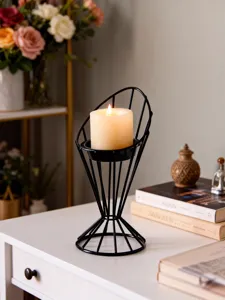 Modern minimalist black metal geometric candle holder with scented pillar candle for home decor.