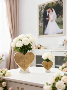 Heart-shaped ceramic vase with gold brushed finish for elegant home decor flower arrangement.