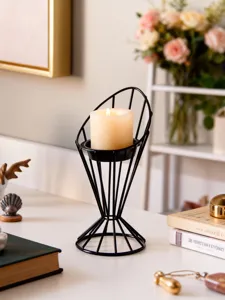 Modern minimalist black metal wire candle holder with scented pillar candle for decor.