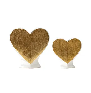 Detail view of gold textured ceramic heart vase pair home decor ornament elegant style.