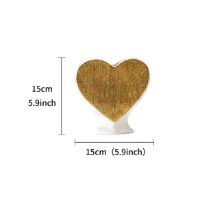Gold and white ceramic heart vase detail, luxury flower container for home room decor.