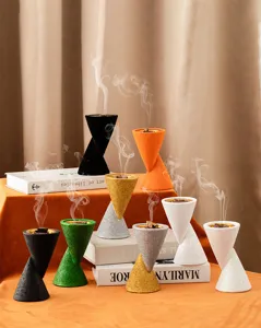 Detailed view of colorful double-cone resin incense burners with artistic hourglass design.