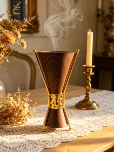Luxury wood grain incense burner with gold metal frame, elegant Arabic style home decor detail.