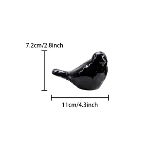 Detailed view of the black ceramic bird figurine, showing precise dimensions and smooth glaze.
