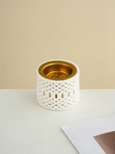 Detailed view of a white 3D printed ceramic incense burner featuring a golden metal bowl.