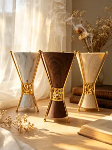 Detail view of luxury Middle Eastern incense burner, elegant gold metal stand with marble finish.