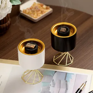 Modern Nordic ceramic incense burner with high gold metal stand, elegant home aromatherapy decor.