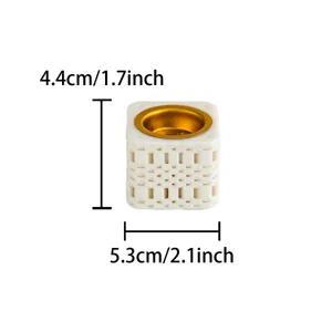 Detailed view of white ceramic 3D printed incense burner with gold metal cup and lattice design.