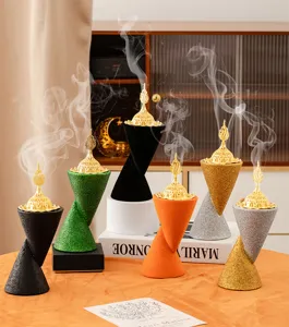 Detailed view of Arabic resin incense burners with gold hollow lids, multi-colored cone bases.
